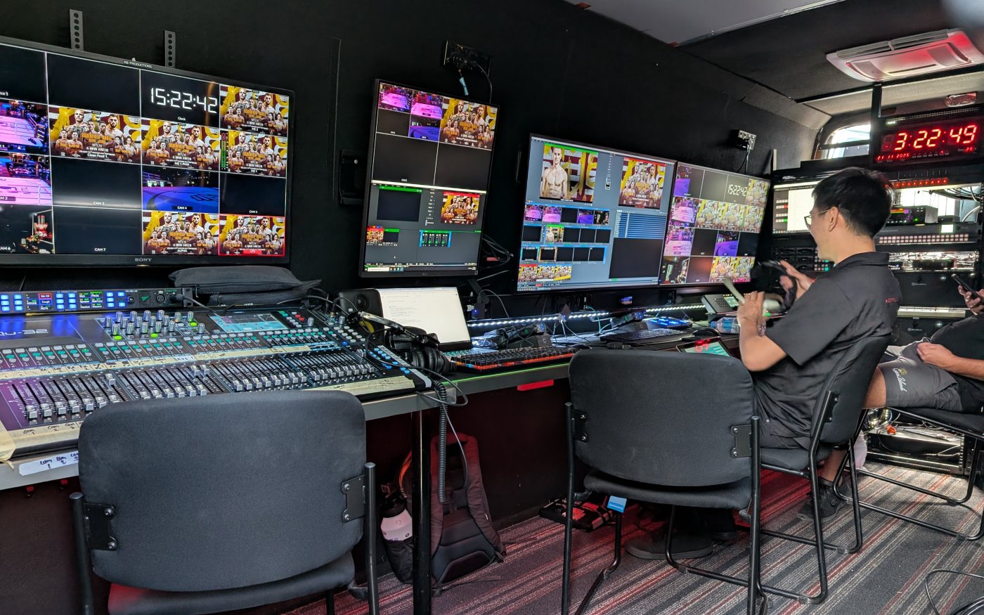 Inside the van during a show: the audio desk, multiviewer, replay and switcher screens, the show clock and crew at work