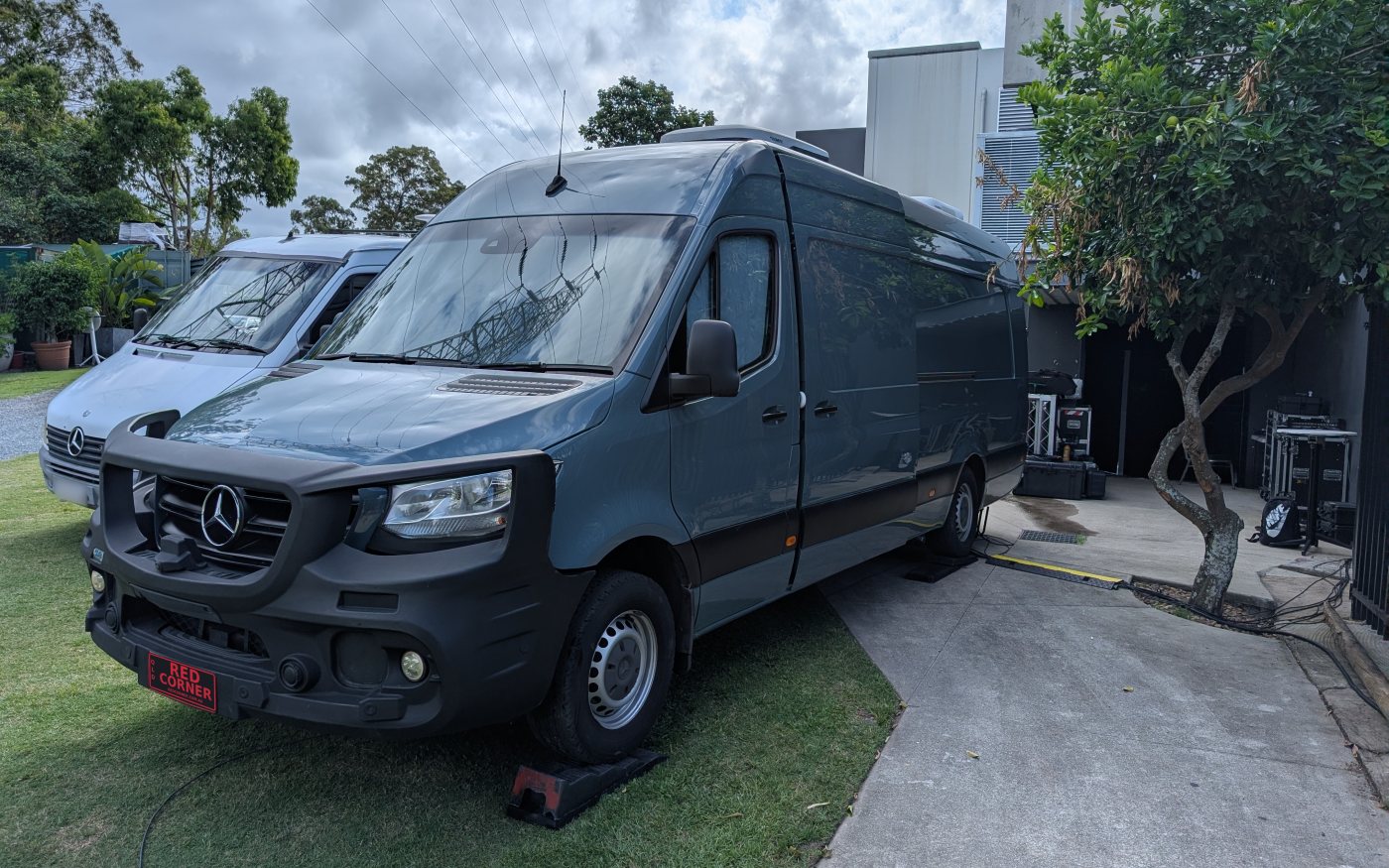 The Red Corner outside broadcast van, a Mercedes Sprinter, parked beside a venue with cables run in through a cable ramp